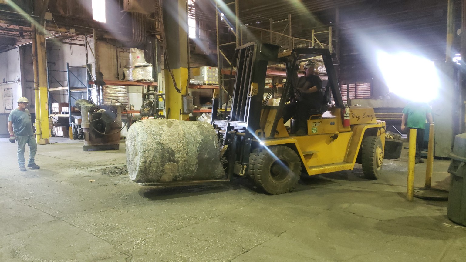 Forklift moving a large cylindrical industrial part