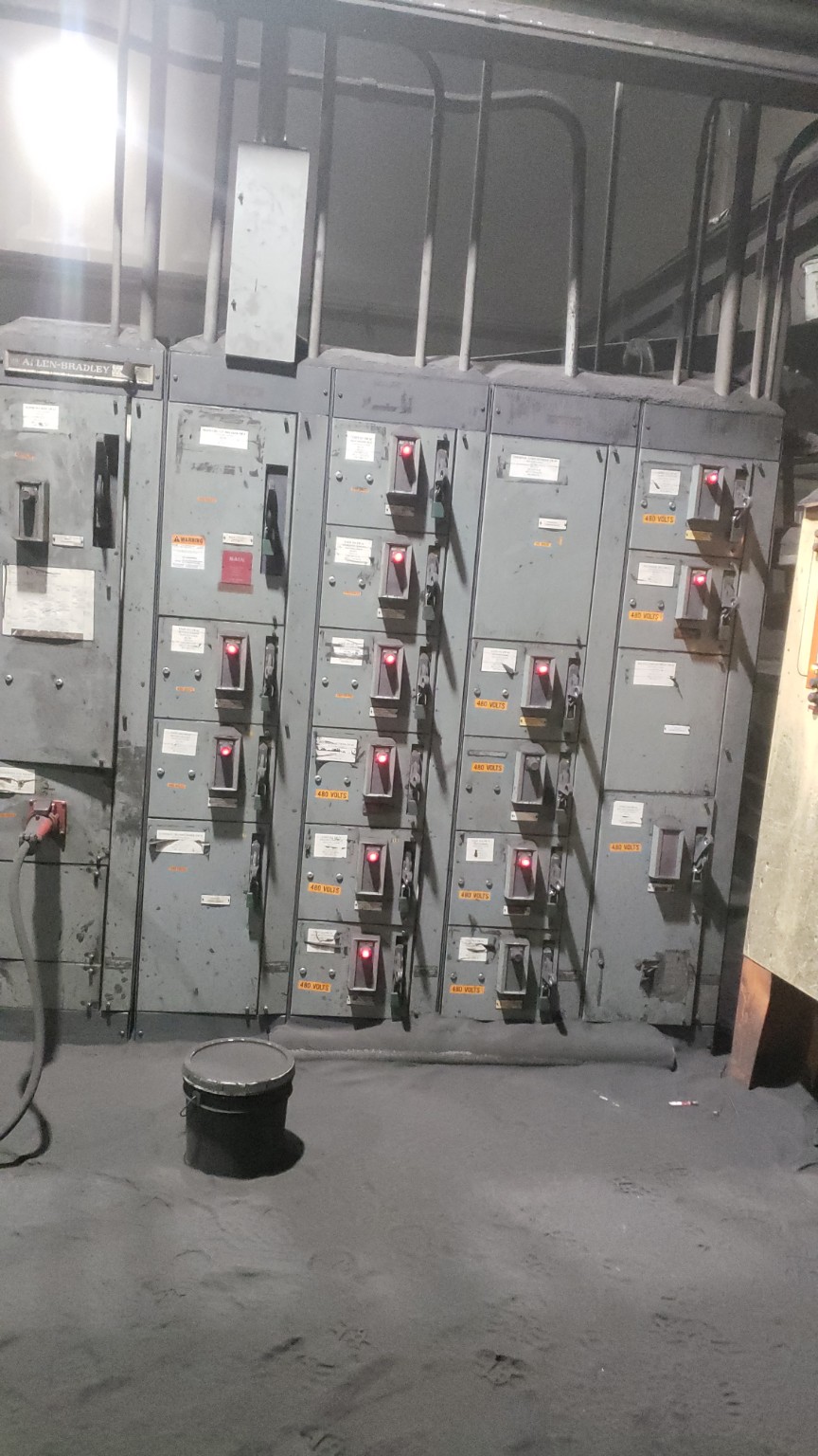 Worker foot on elevated grate above a high-consequence industrial area